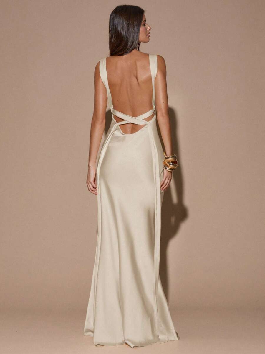 Back view of ivory sleeveless deep V-neck maxi dress with crossed open back, shown for wedding and evening wear