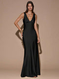 Back view of black sleeveless deep V-neck maxi dress with crossed open back, shown for wedding and evening wear
