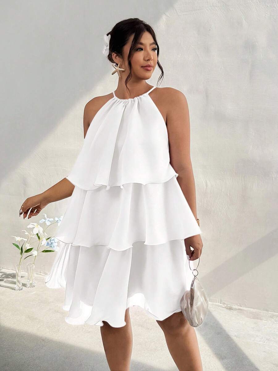 Front view of white tiered halter dress with ruffles