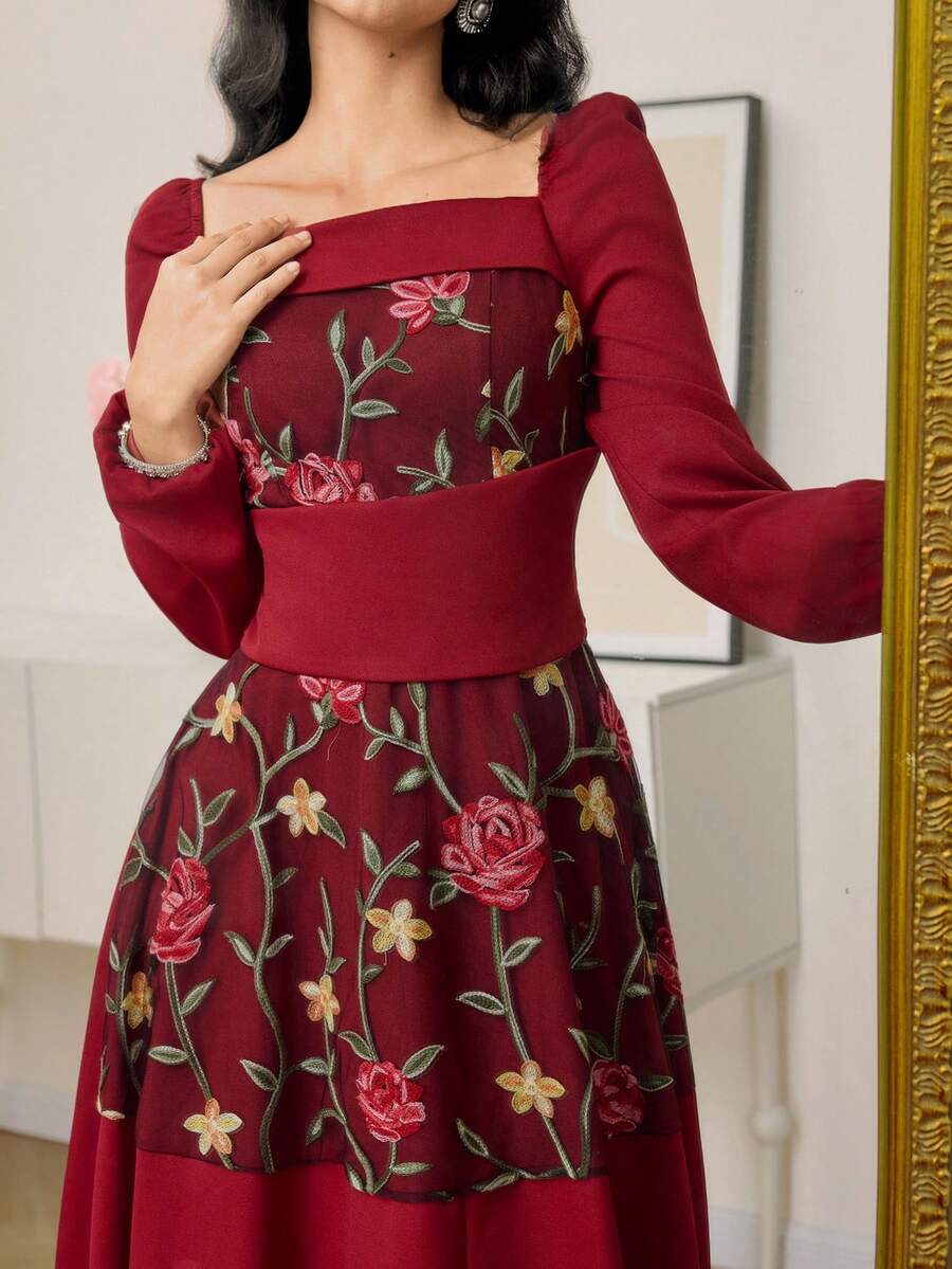 Close view of burgundy floral embroidered mesh bodice and high waist detail