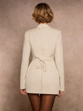 tailored blazer mini dress in burgundy, black and cream with deep V notched lapels, long sleeves, structured shoulders, three gold buttons, cinched waist, back tie, front draped mini skirt and side ruching slit image 8