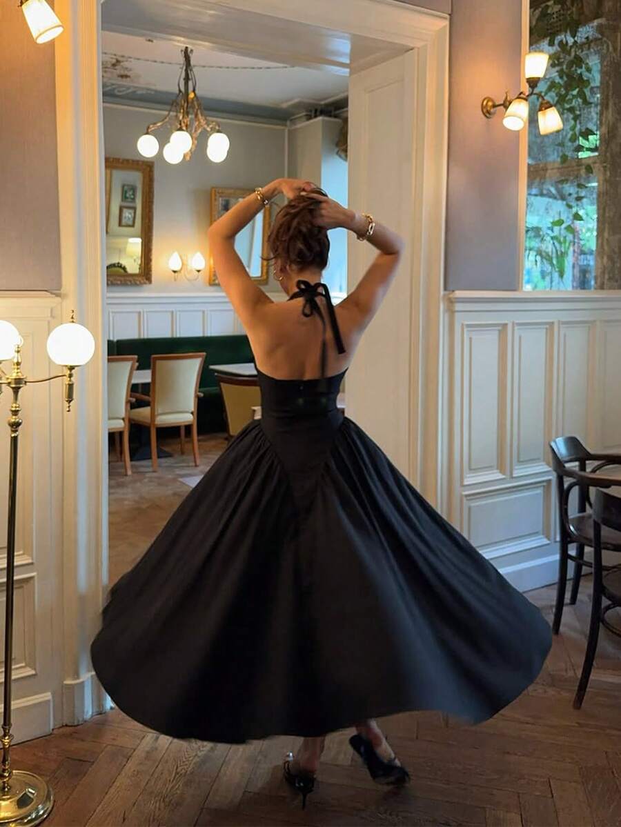 Back View of black halter A-line cocktail dress with open back for wedding and party styling