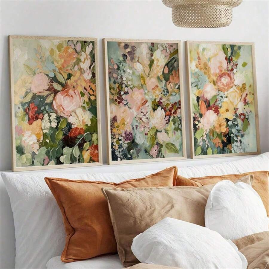 Pastel wildflower canvas triptych in slim frames displayed above a green living room sofa