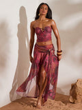 Front full view of burgundy abstract print ruched bandeau top and high-slit mesh maxi skirt two-piece set for beach vacation styling