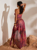 Back view of burgundy abstract print ruched bandeau top and high-slit mesh maxi skirt two-piece set for beach vacation styling