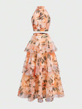 Front view of ivory floral halter crop top and long tiered skirt outfit
