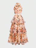 Back view of ivory botanical crop top and flowing layered maxi skirt