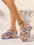 Model wearing colorful abstract print wedge sandals with thick platform soles