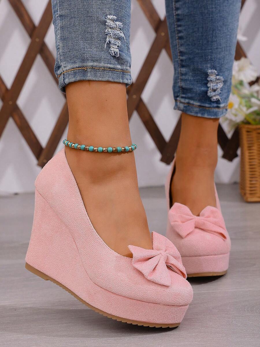 Elevate your spring wardrobe with these stunning pink wedge slip-ons, the perfect fusion of comfort and sophistication. The delicate bowknot accent adds a touch of feminine charm, while the slip-on design means you can slip them on and go. Built with premium suede leather uppers and a supportive PU leather lining, these court wedges deliver both durability and softness underfoot. The high wedge heel provides a graceful lift without sacrificing stability, making them ideal for work, weekend outings, or cozy 