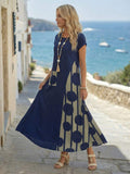 Navy maxi dress side view showing swing hem and abstract print panel