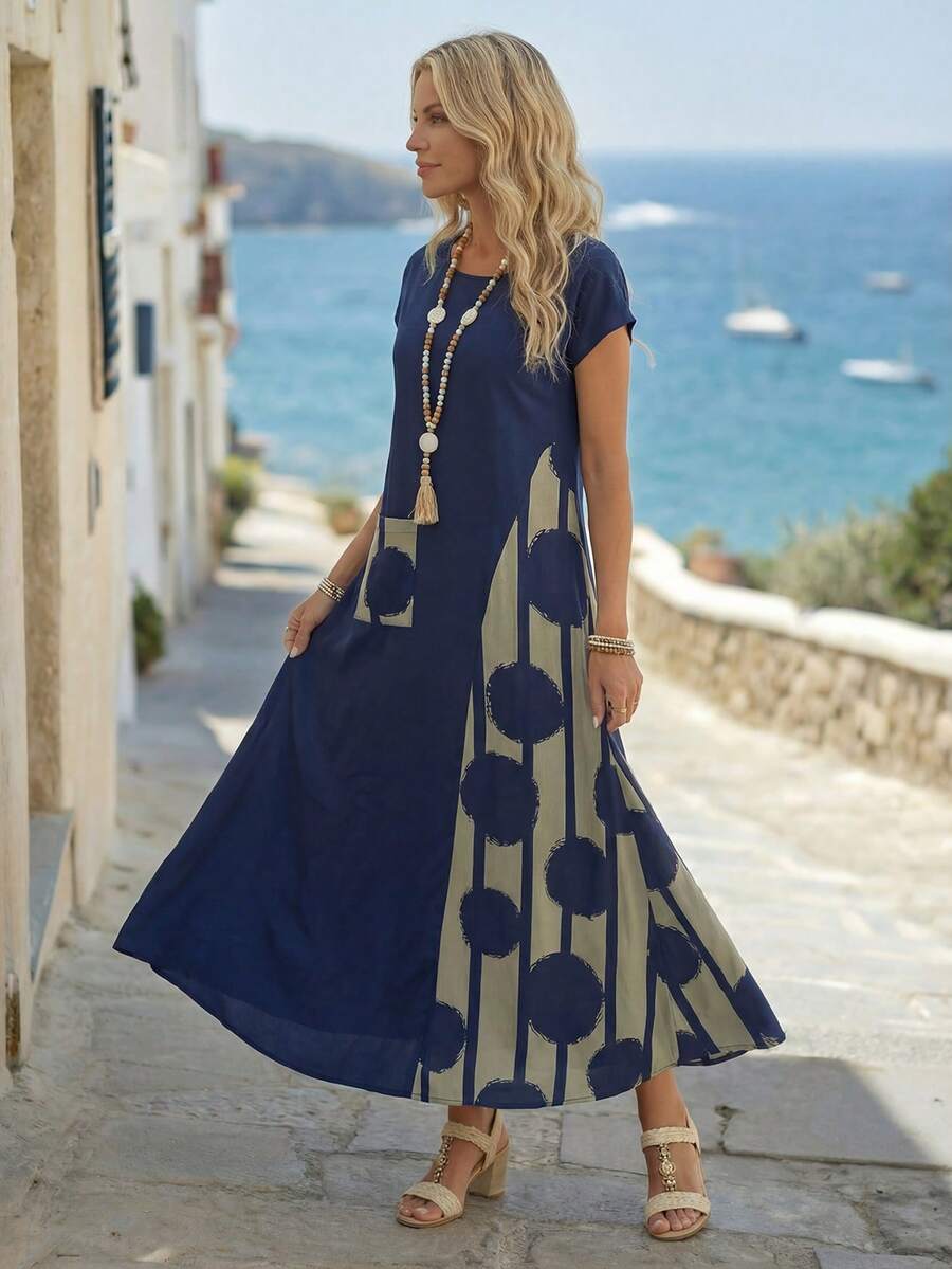 Navy maxi dress side view showing swing hem and abstract print panel