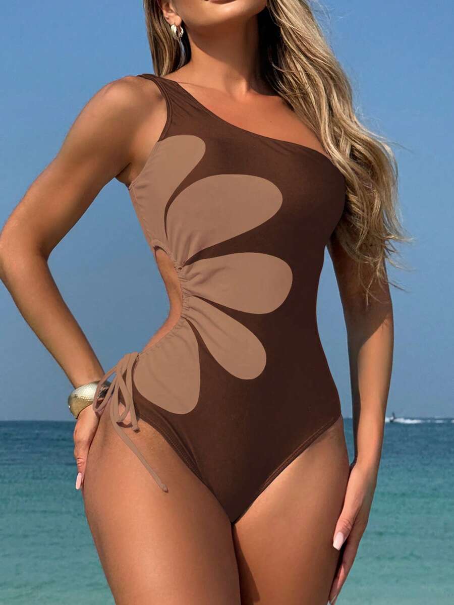 Make a splash this season in our One-Shoulder Tropical Hibiscus One-Piece Swimsuit. Featuring a vibrant hibiscus print and effortless one-shoulder design, this boho-inspired piece brings island vibes to every beach day, pool party, and summer festival. The flattering one-piece silhouette offers comfortable coverage while the tropical pattern captures that carefree, wanderlust aesthetic. 