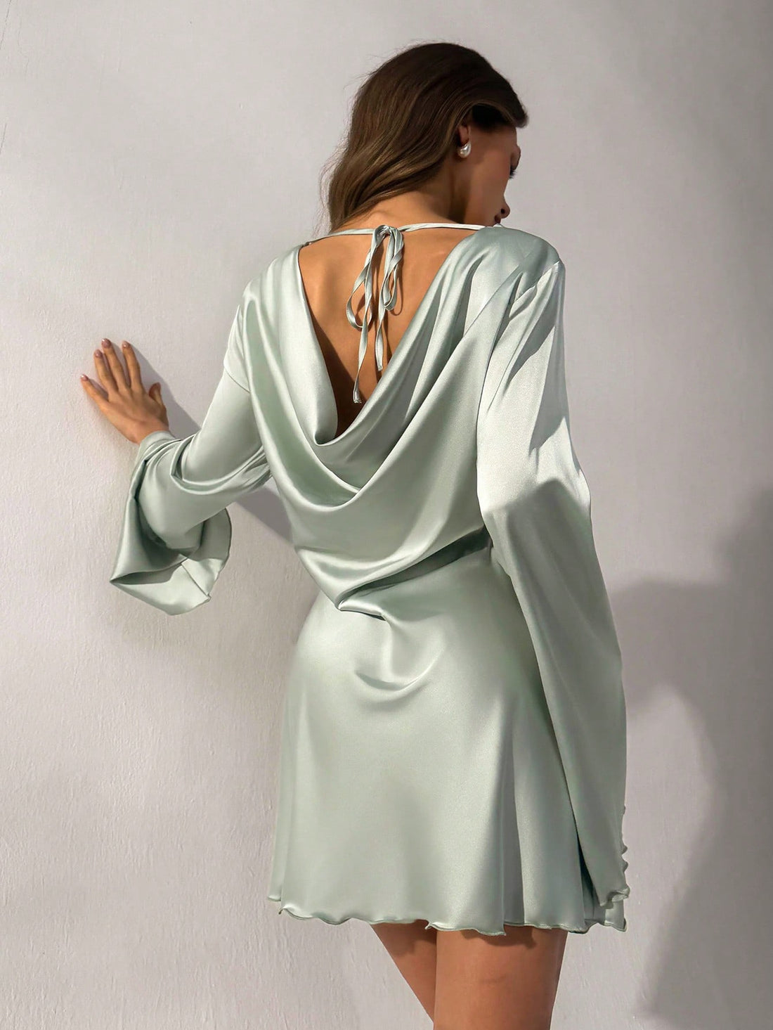 This sophisticated light green backless dress captures the essence of spring romance with its expertly draped design. The open back creates an alluring silhouette while maintaining refined elegance, making it an ideal choice for special occasions and intimate gatherings. The flowing fabric moves gracefully with you, offering both comfort and visual appeal. Whether you're attending a garden date or afternoon tea, this piece delivers understated luxury and timeless appeal. A versatile wardrobe essential for t