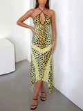 Back view of yellow leopard print dress showing deep open back and tie-neck straps
