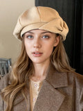 Front portrait of model wearing warm beige bow beret with gathered crown