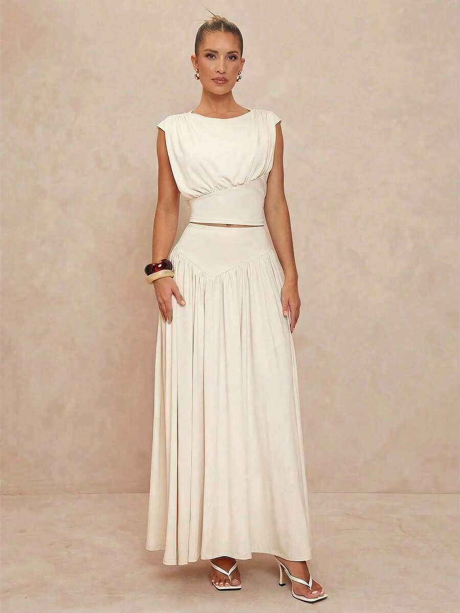 Elevate your formal wardrobe with this stunning two-piece set featuring an apricot boat neck blouse with delicate ruffle detailing and a fitted A-line skirt. The blouse showcases cap sleeves and a lined bodice crafted from a luxurious polyester-elastane blend with medium stretch for comfort and movement. The long skirt features a classic A-line silhouette that flatters every figure. Perfect for upscale parties, galas, and formal occasions, this coordinated set offers effortless elegance. The medium-stretch 