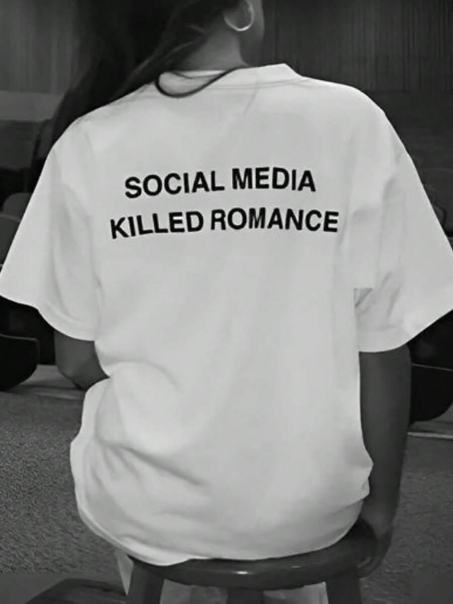 Worn back view of loose white T-shirt with Social Media Killed Romance graphic