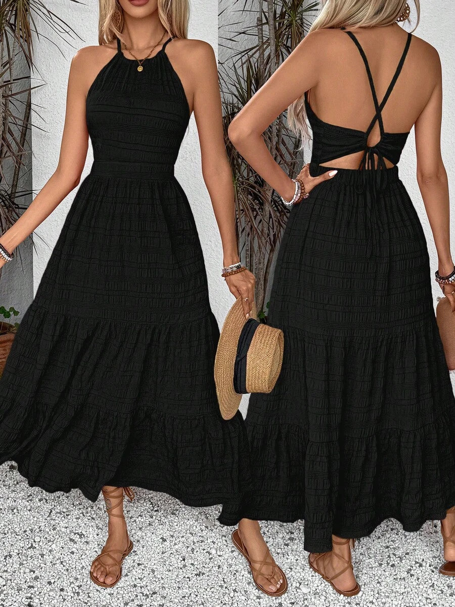 Black halter maxi dress with smocked bodice tiered skirt and straw hat