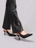 Black slingback pump worn with faux leather pants for evening styling