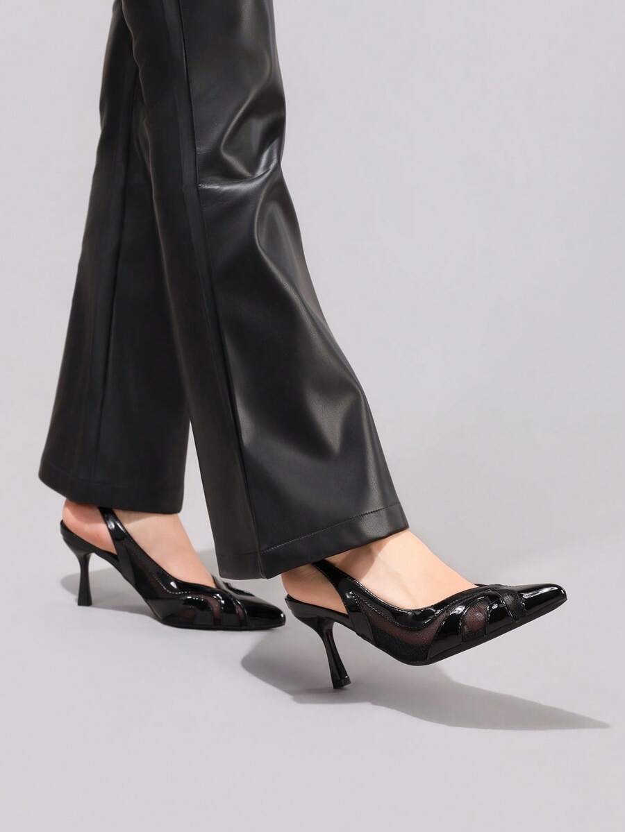 Black slingback pump worn with faux leather pants for evening styling