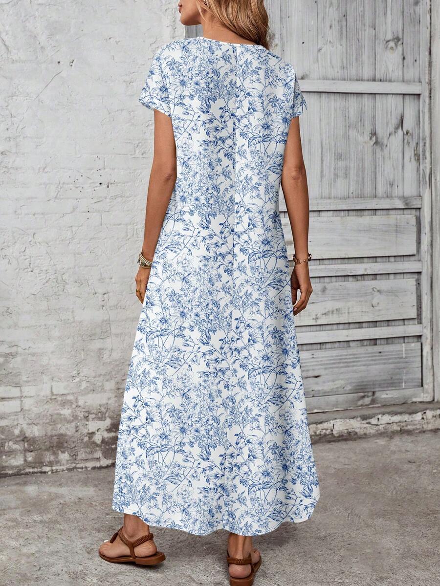 Back view of blue and white botanical maxi dress with center seam and short sleeves