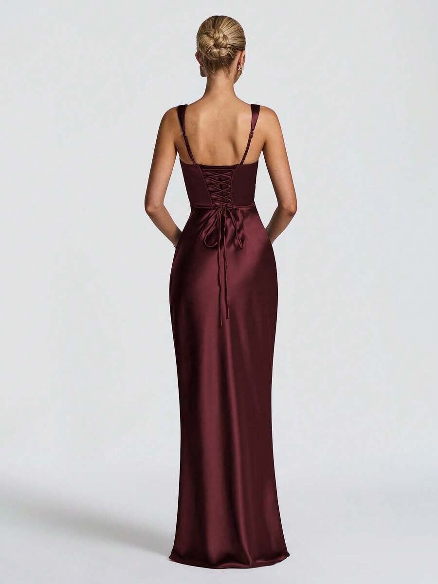 Rear view of burgundy satin gown showing lace-up back panel and long fitted mermaid skirt