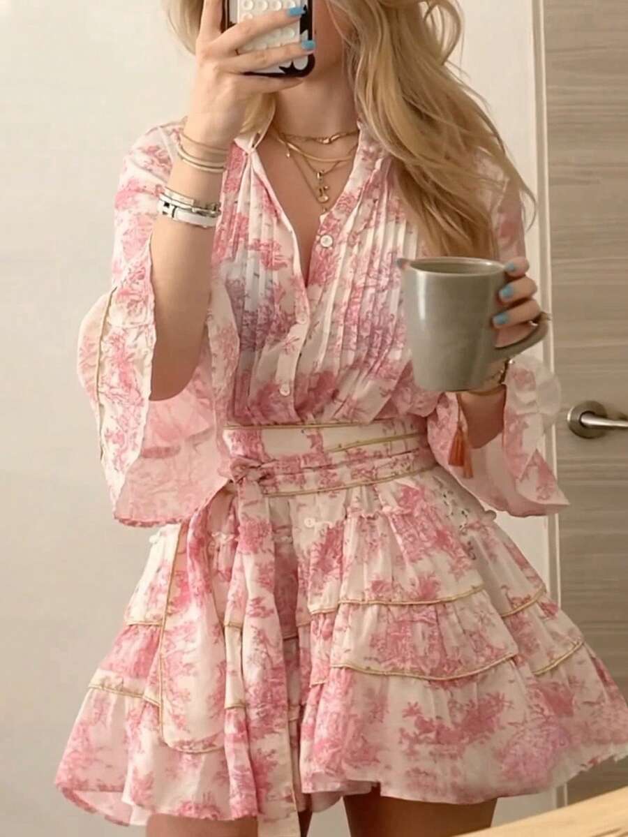 Embrace effortless elegance with this charming floral print button-front dress, designed for romantic getaways and casual adventures. The notched neckline and three-quarter flare sleeves create a flattering silhouette, while the high-waisted A-line cut offers comfortable all-day wear. Layered ruffle hem and knot details add playful boho flair. Crafted from soft woven polyester-elastane blend in a lovely pink hue, this dress transitions seamlessly from beachside strolls to evening dinners. 