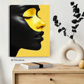 Yellow and black portrait canvas print above modern console
