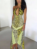 Front view of yellow leopard print halter maxi dress showing fitted long silhouette