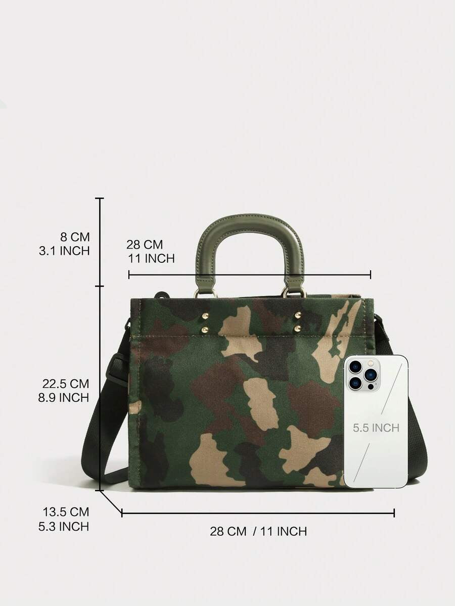 Three-quarter view of army green camouflage fabric handbag with rounded handles and black shoulder strap