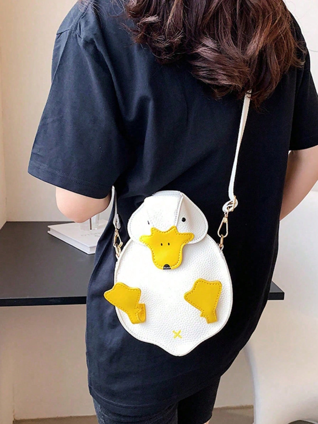Elevate your accessory game with this charming duck-shaped crossbody bag, expertly crafted from durable PU leather. The whimsical 3D design makes a distinctive style statement while the compact silhouette proves perfect for minimalist carrying. Featuring an adjustable shoulder strap for versatile wear and a functional coin purse compartment, this mini bag seamlessly transitions from casual daytime outings to evening gatherings. The structured construction maintains its shape while remaining lightweight, mak