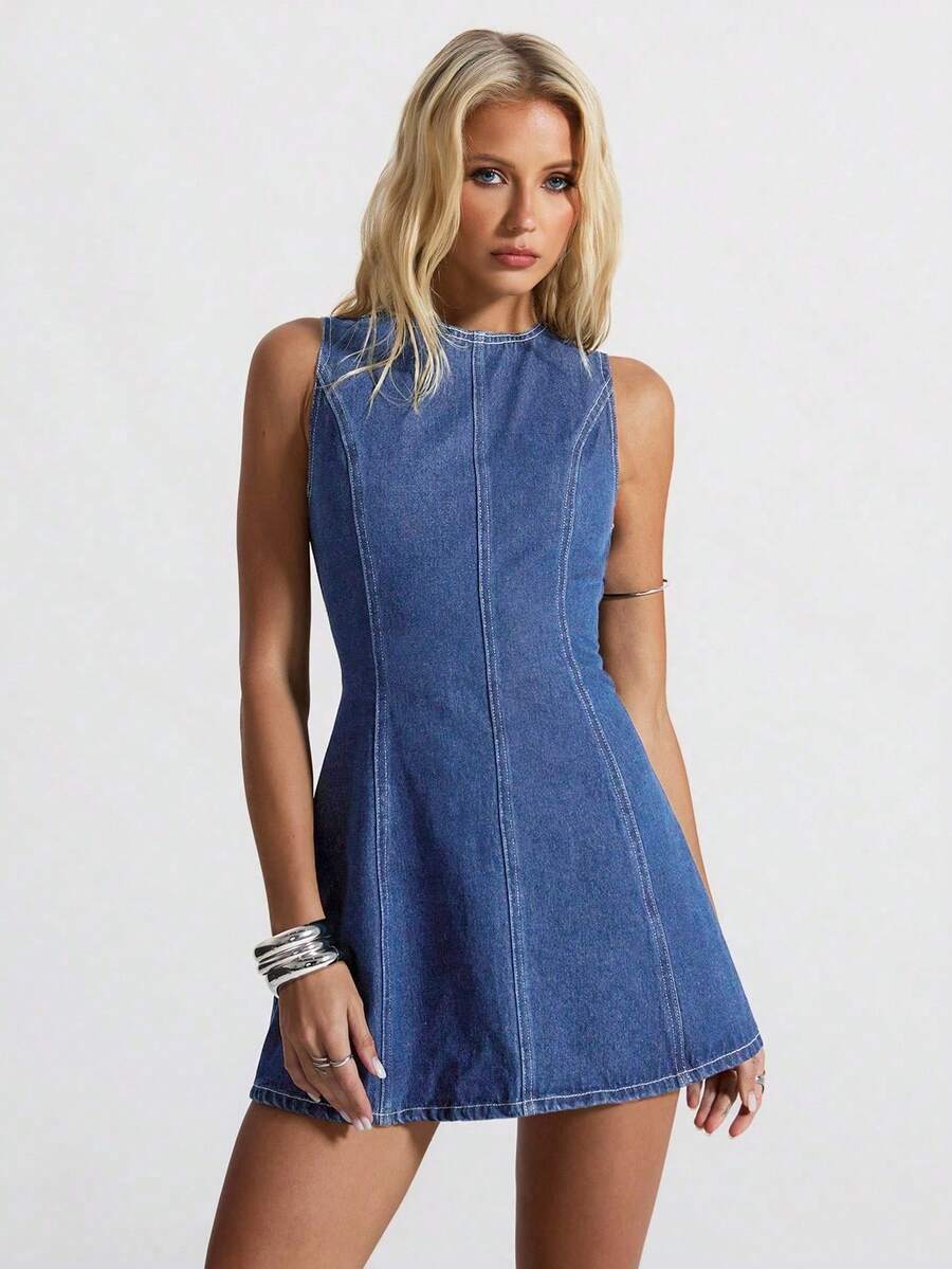 Near-front portrait of medium-wash denim mini dress with round neck and contrast seamwork