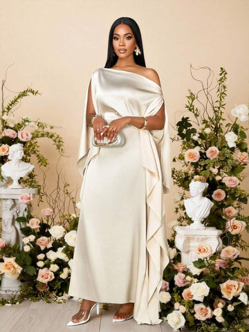 Front view of apricot ivory satin asymmetric maxi dress styled with silver clutch for formal occasion