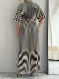 Back view of striped belted wide-leg jumpsuit showing visible color, print, and silhouette