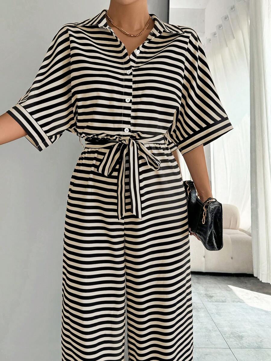 Close detail view of striped belted wide-leg jumpsuit showing visible color, print, and silhouette