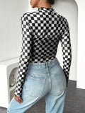 Rear three-quarter view of black and white checkerboard long-sleeve fitted top