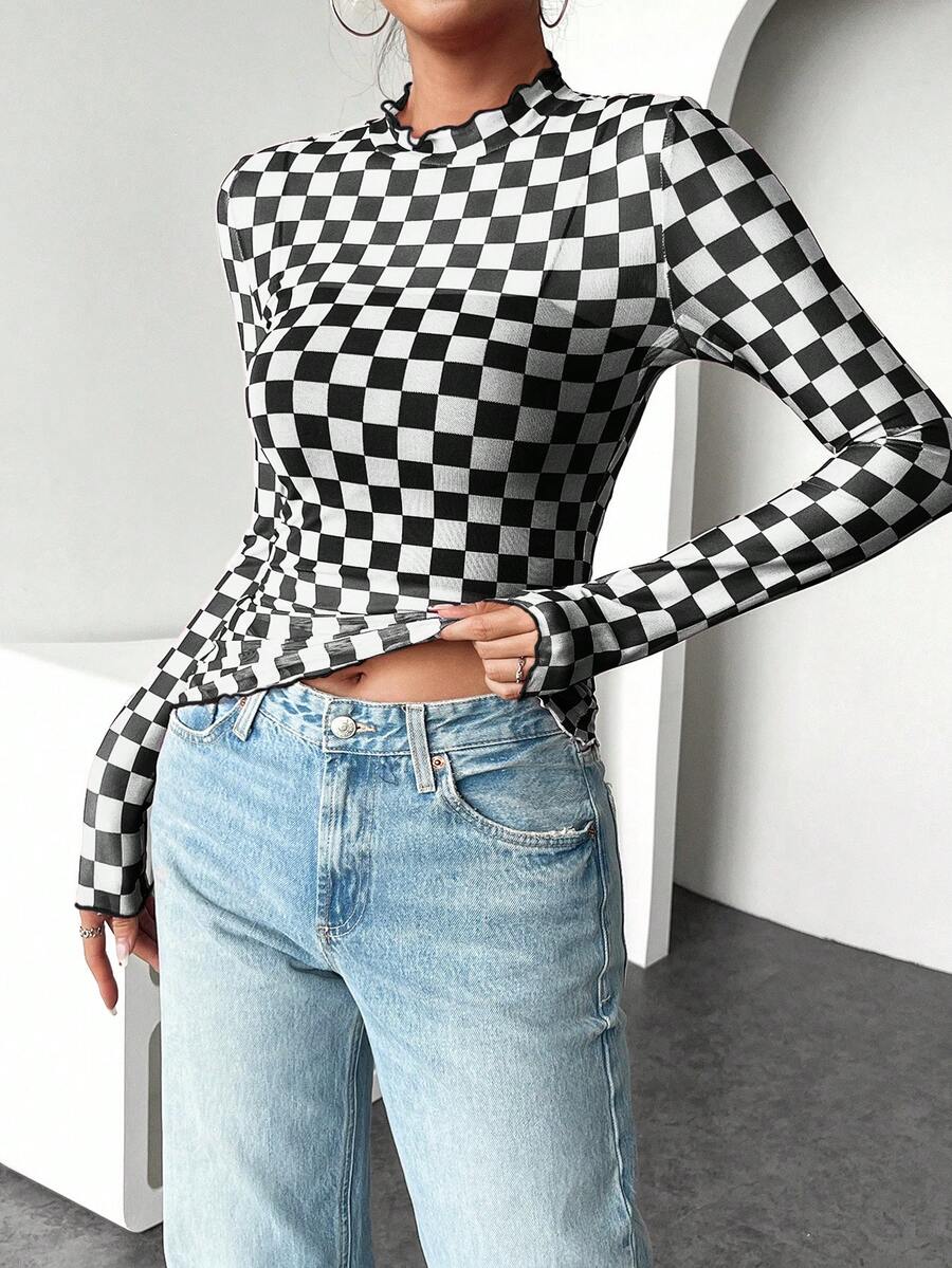 Close front view of black and white checkerboard knit shirt with lettuce-trim collar and hem