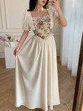 Close detail view of vintage floral tapestry bodice puff sleeve maxi dress showing visible color, print, and silhouette