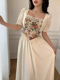 Styled view of vintage floral tapestry bodice puff sleeve maxi dress showing visible color, print, and silhouette