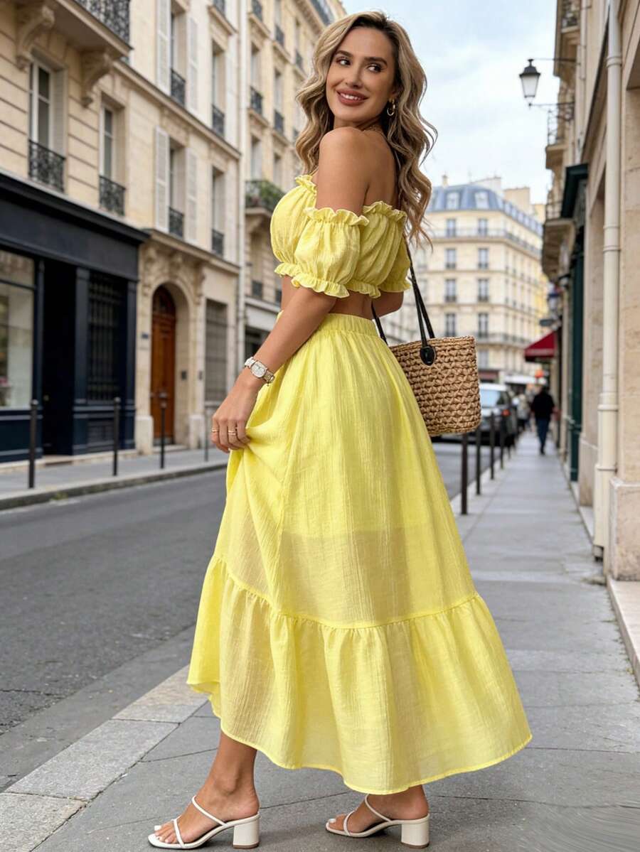 Elevate your spring and summer wardrobe with this enchanting yellow two-piece set. The romantic off-the-shoulder blouse features delicate puff sleeves, shirring, and playful ruffled details for effortless boho charm. Pair it with the flowing long skirt for a polished look perfect for weddings, formal events, or festive celebrations. Crafted from a breathable lyocell and polyamide blend, this slim-fit ensemble offers comfort and style. Machine washable for easy care.