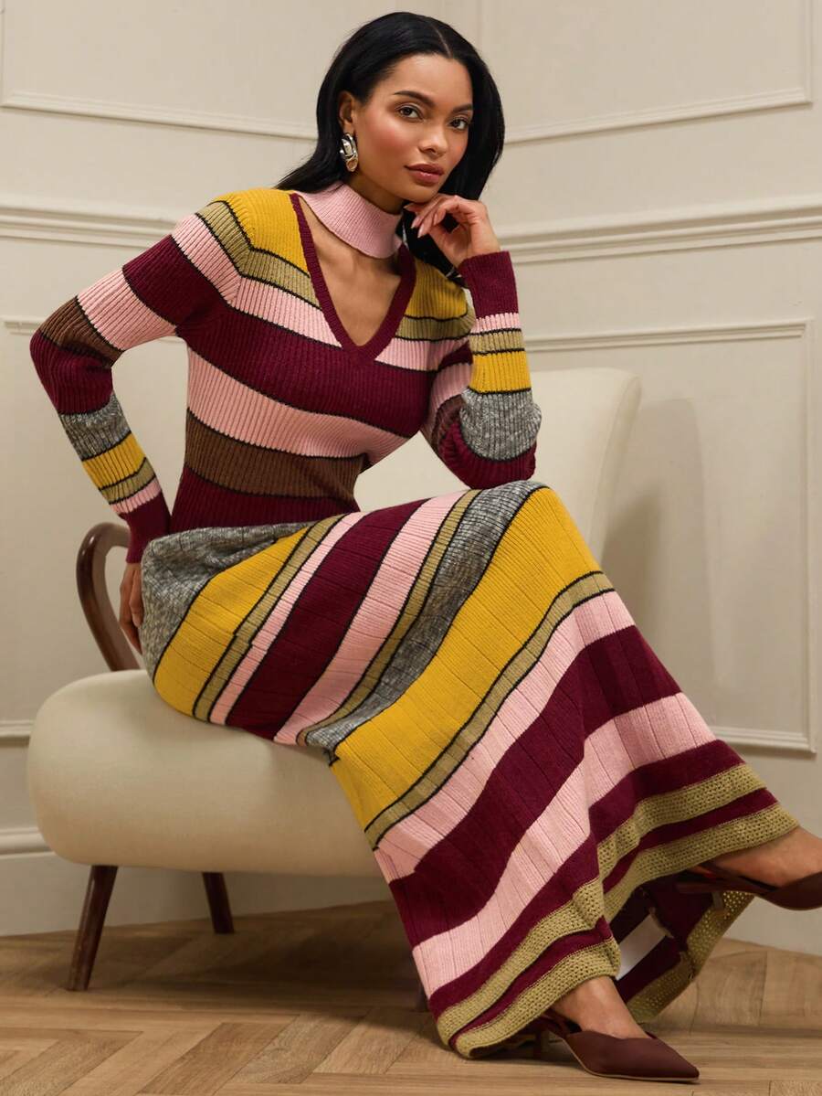 Seated front view of striped keyhole sweater maxi dress with flared skirt