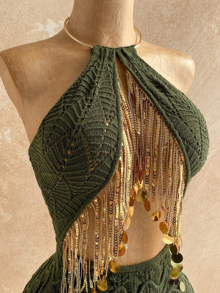 Elevate your summer wardrobe with this eye-catching sequin tassel halter knit dress. The shimmering sequin detailing and playful tassel accents create instant glamour, while the flattering halter neckline offers elegant support. 