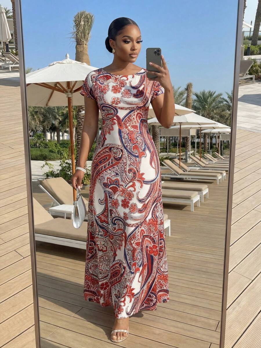 Embrace effortless summer style in the Fleurora Plus Size Beach Dress. This boho-inspired A-line dress features an eye-catching allover print in vibrant multicolor tones, perfect for vacation getaways and warm-weather adventures. The round neckline and short sleeves offer comfortable everyday wear, while the natural waist cinch creates a flattering silhouette. Crafted from a soft knitted fabric blend of 91% polyester and 9% elastane, the medium stretch material moves with you for all-day comfort. 