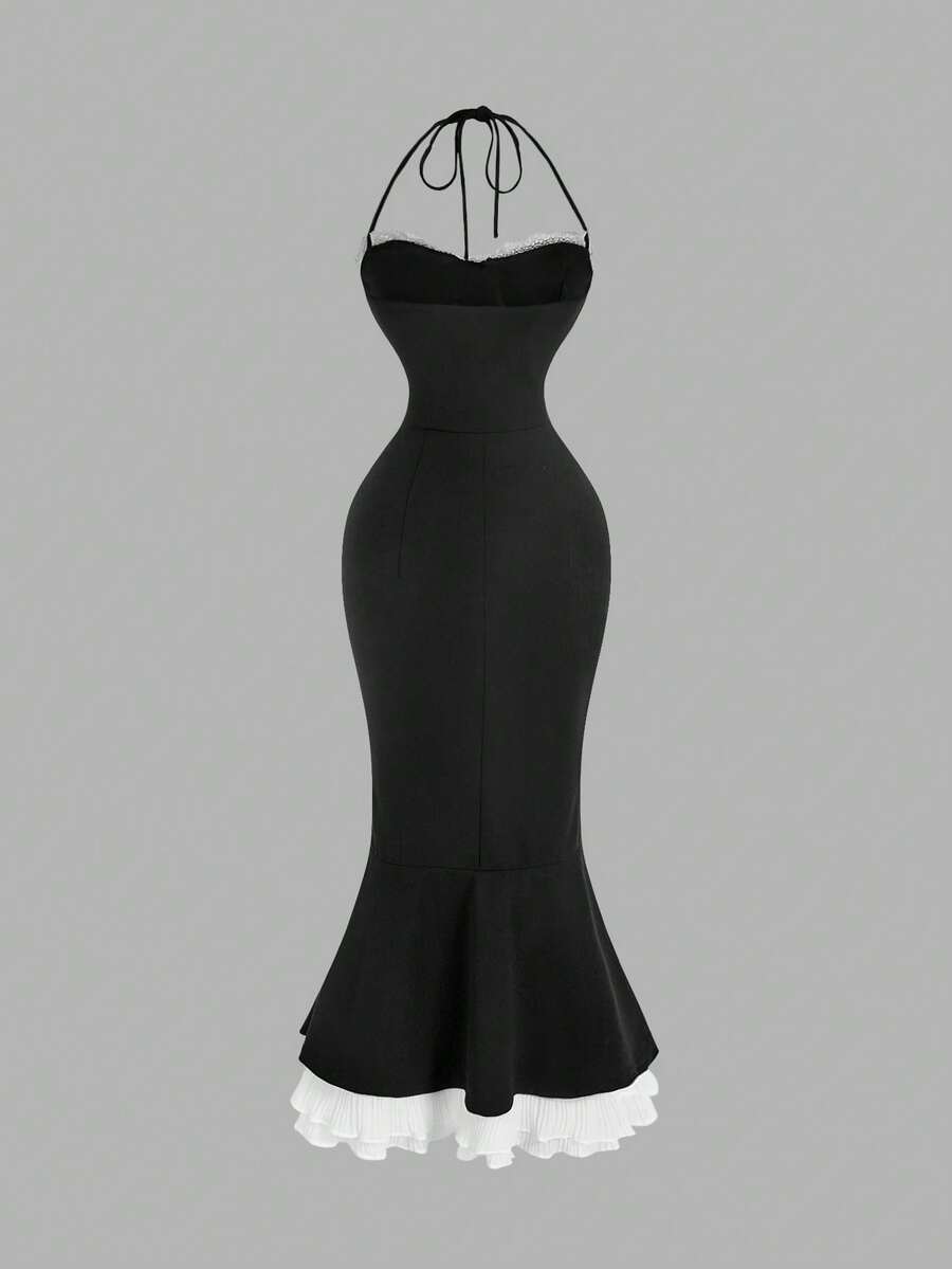 Back view of black halter mermaid midi dress with white layered ruffle hem