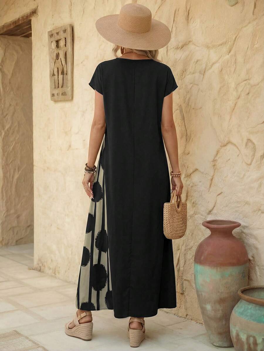 Back view of black loose maxi dress with solid back and long straight hem