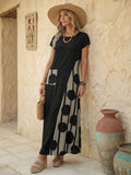Black resort maxi dress angled front view showing abstract print panel