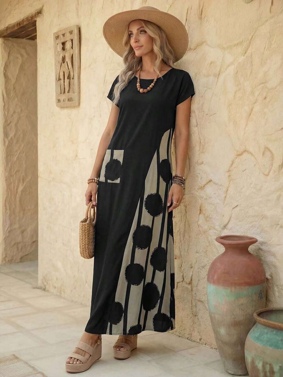 Black resort maxi dress angled front view showing abstract print panel