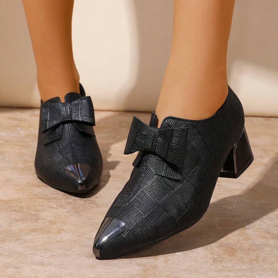Elevate your style with these stunning glossy pointed high heels featuring an adorable bow detail. Crafted from premium PU leather, these slip-on beauties combine elegance with everyday comfort thanks to their chunky heel design. Perfect for parties, date nights, or any occasion that calls for a touch of sophistication. The sleek black finish and eye-catching bow accent make them a versatile addition to any fashion-forward wardrobe. Step out with confidence and turn heads wherever you go.