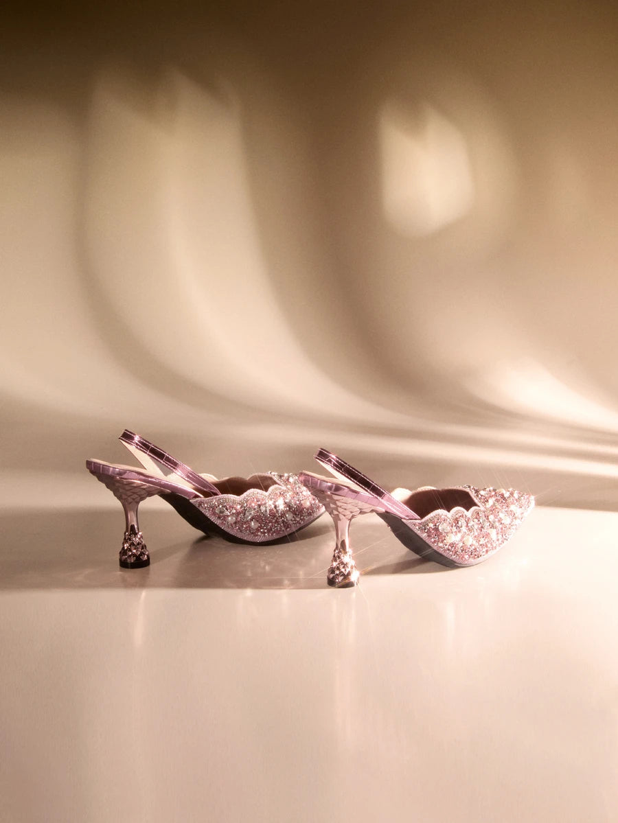 Make a statement at your next special occasion with these stunning pink rhinestone backless high heels. Featuring a sophisticated pointed toe design and eye-catching rhinestone embellishments, these sandals deliver glamour and elegance for weddings, parties, and formal events. The backless silhouette offers a modern, daring aesthetic while the high heel provides a flattering lift. Perfect for those seeking a show-stopping shoe that combines sparkle with refined style.