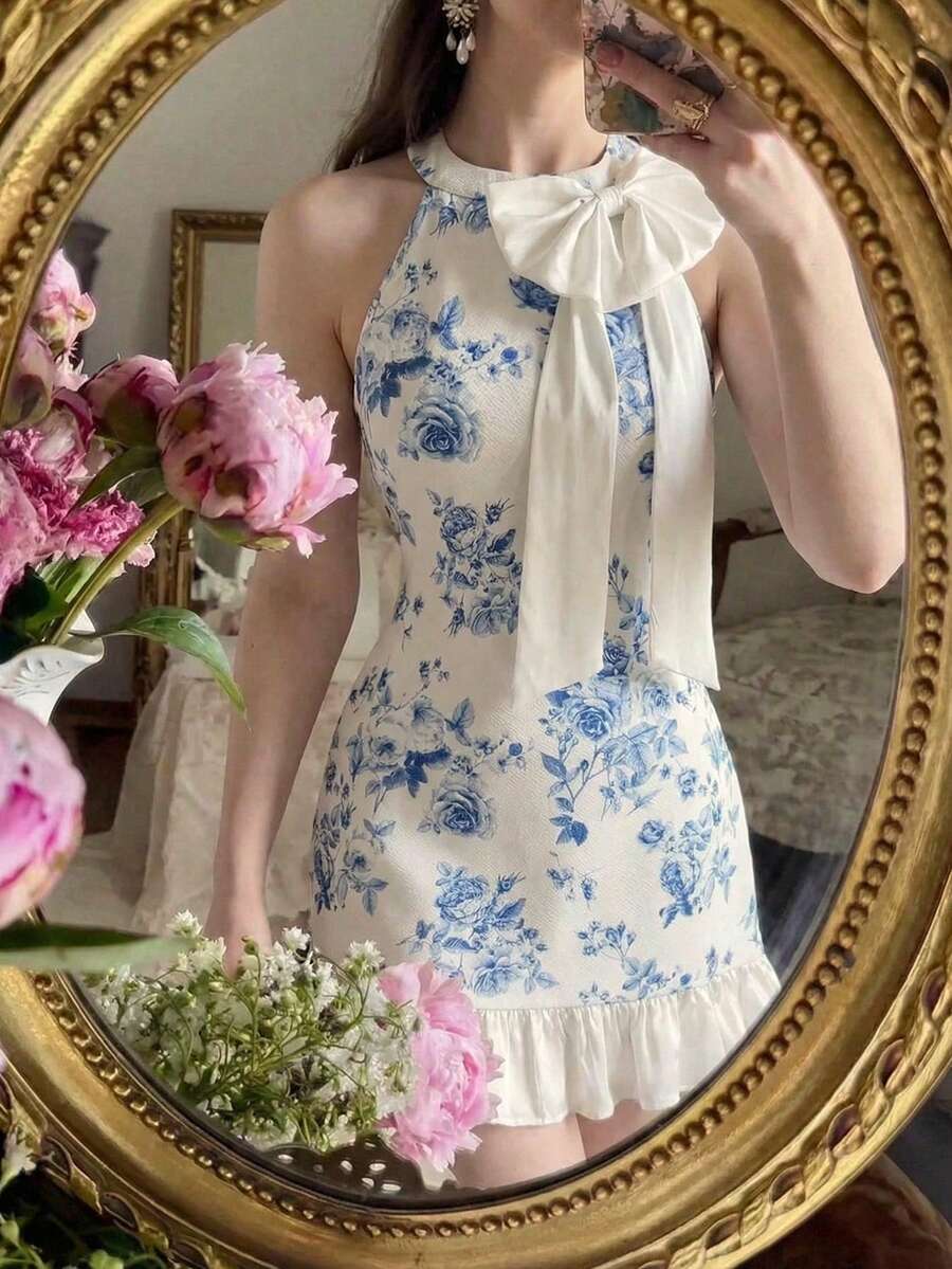 This refined blue and white floral mini dress combines timeless elegance with contemporary style, making it an ideal choice for spring and summer adventures. The distinctive bow collar detail adds sophistication and visual interest, while the botanical print brings fresh, seasonal appeal. Designed with versatility in mind, this piece works beautifully for resort wear, casual outings, or evening occasions. The mini length offers a modern silhouette that flatters various body types, ensuring you look and feel